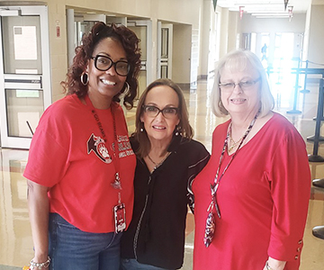 Three happy women smiling for the camera