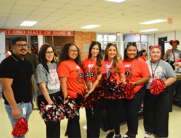 Group of spirited staff members in red and black attire
