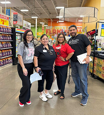 Four happy team members at a super store