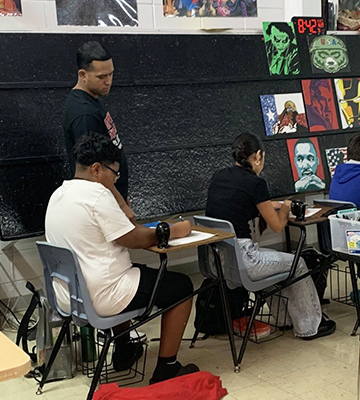 Teacher helping a student at their desk