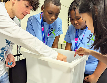 Students looking into a bin