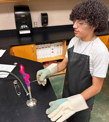 Male student conducting a science experiment in the science lab