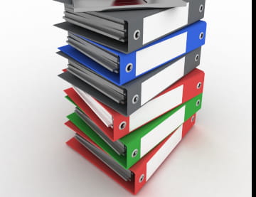 A stack of large three-ring binders