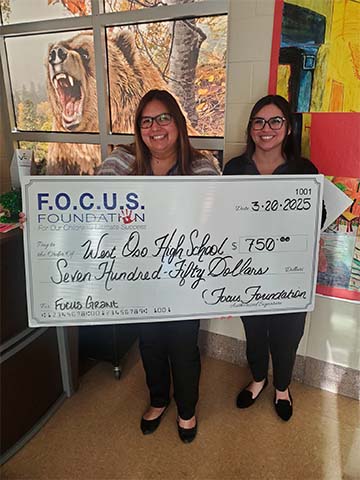 Two staff with giant check