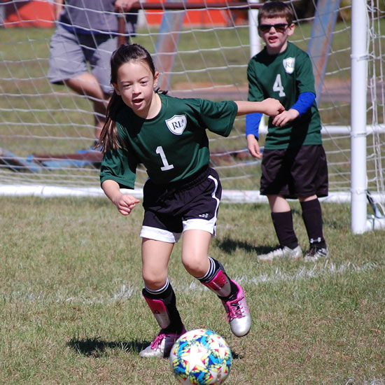 Student playing soccer