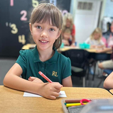 Smiling student at her desk