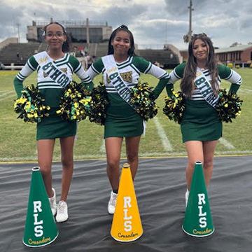 Cheerleaders standing beside the field