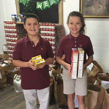Students holding up food