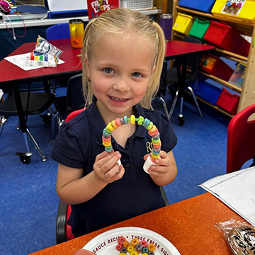 Student creating a project with Fruit Loops and Marshmallows
