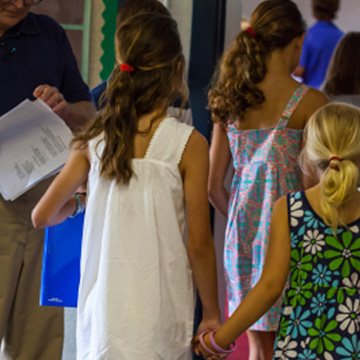 Adults and students walking in the hallway