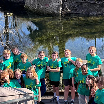 Group picture of students next to a pond
