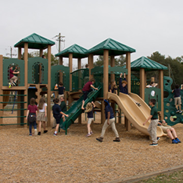 Students playing on playground equipment