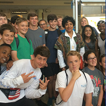 An adult surrounded by students