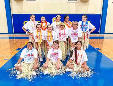 Cheerleaders in hula skirts