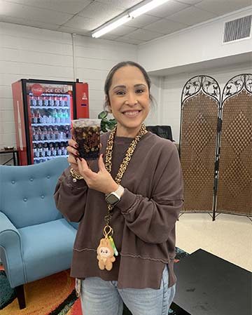 Employee holding a drink