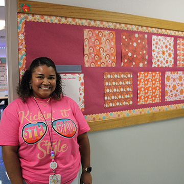 A teacher with a shirt that reads Kickin' it 5th grade style