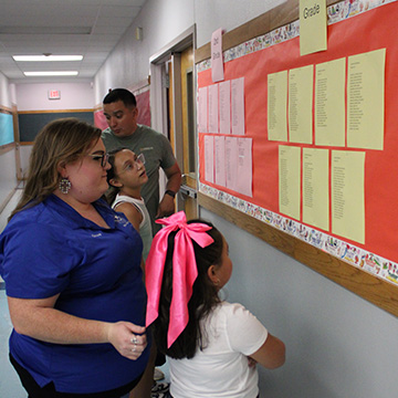 Parents and students looking at an information board