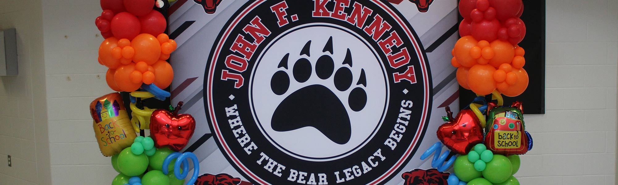 Mural of the school logo decorated with balloons for Back to School