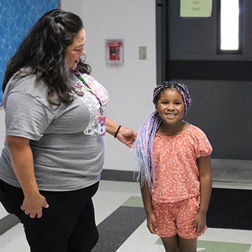 Staff member and student smiling