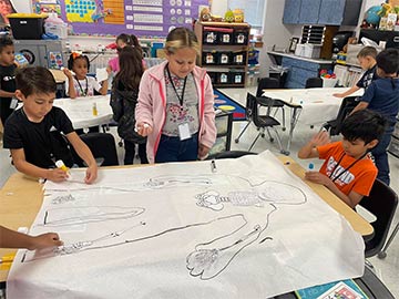 Students working on an anatomy assignment in class