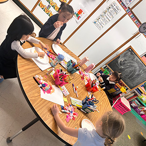 Students sitting around a craft table