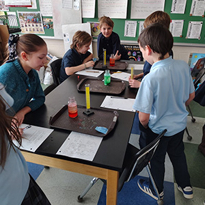 Students working with containers with different colored contents