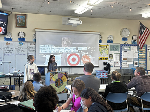 Two girls presenting their project to the panel of judges