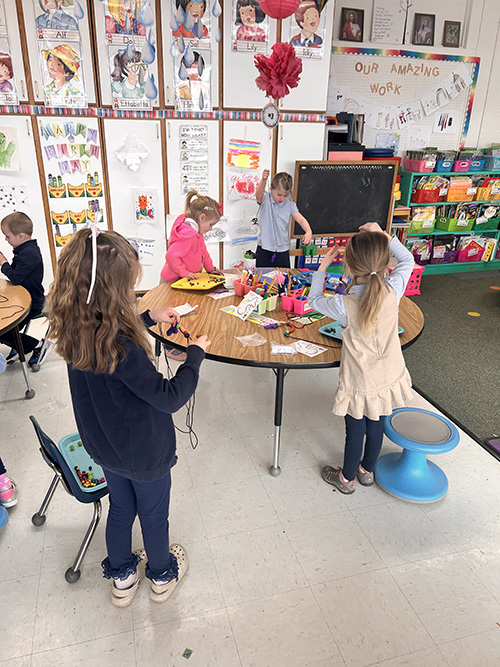 Group of students focused on making their own Rosary beads