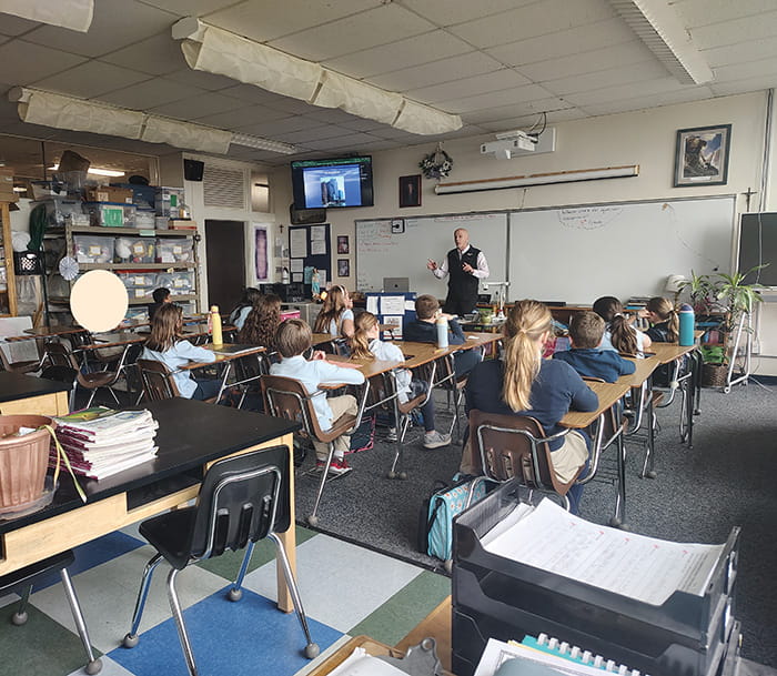 Guest speaker Karl Bohnak speaking to fifth graders in their classroom
