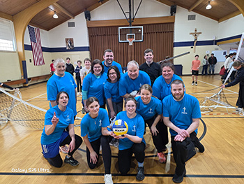 Staff members wearing blue tee shirts in the gym