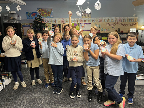 Students holding cookies