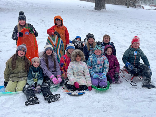 Group photo of students sledding