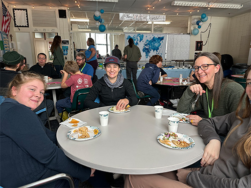 Smiling adults eating