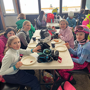 Students taking break from skiing to eat