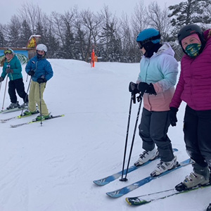 Four students preparing to ski