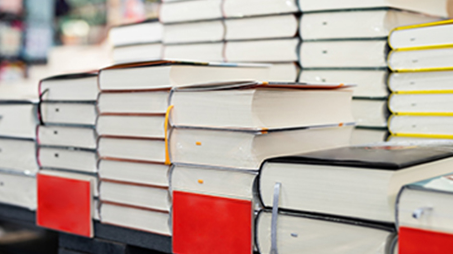Stacks of text books on a table