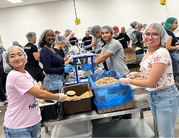NHS students helping to make meals in a kitchen
