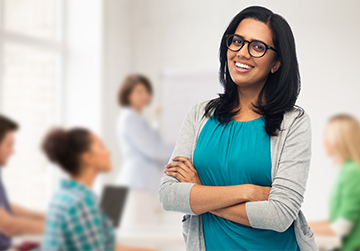 Happy teacher in her classroom