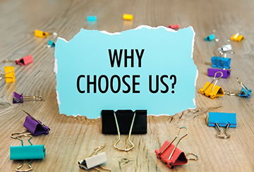 Why Choose Us? on a note next to colorful clips