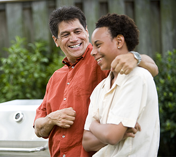 Dad talking to son and smiling