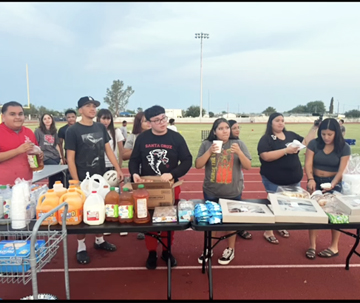 Students manning a food table on the track