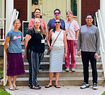 Teacher working with two students at her desk
