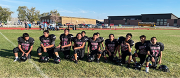 Football team posing for a picture outside