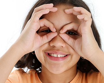 Child using hands as glasses
