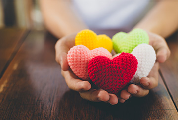 Nurse holding a bunch of stuffed hearts