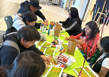 Parents and students making crafts at a table
