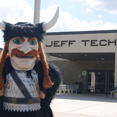 mascot in front of school