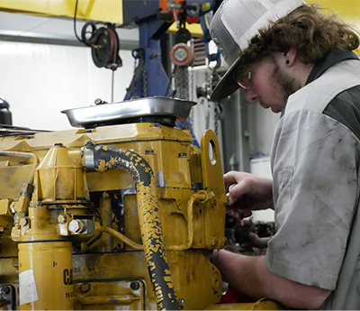 Student working on heavy equipment