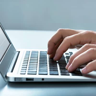 Person typing on a laptop