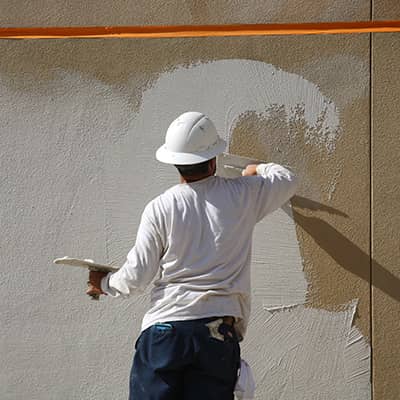 A person plastering a wall